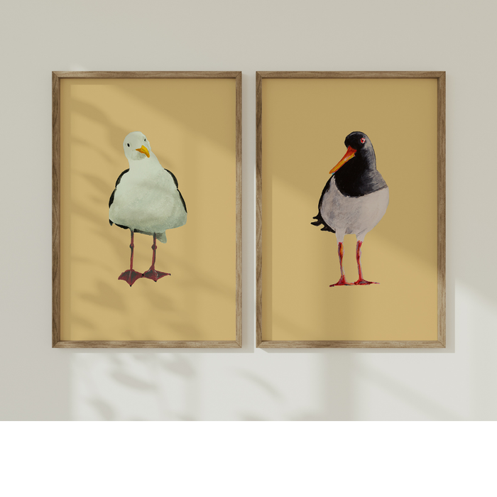 Set of two framed paintings of birds on a yellow background