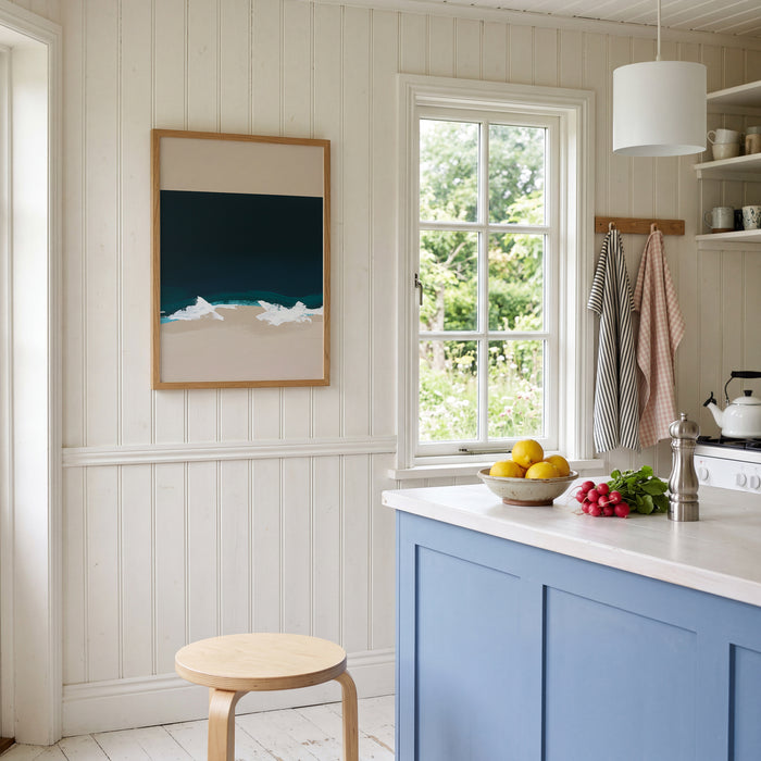 Kitchen interior with blue cabinets, white countertop, and a window view.
