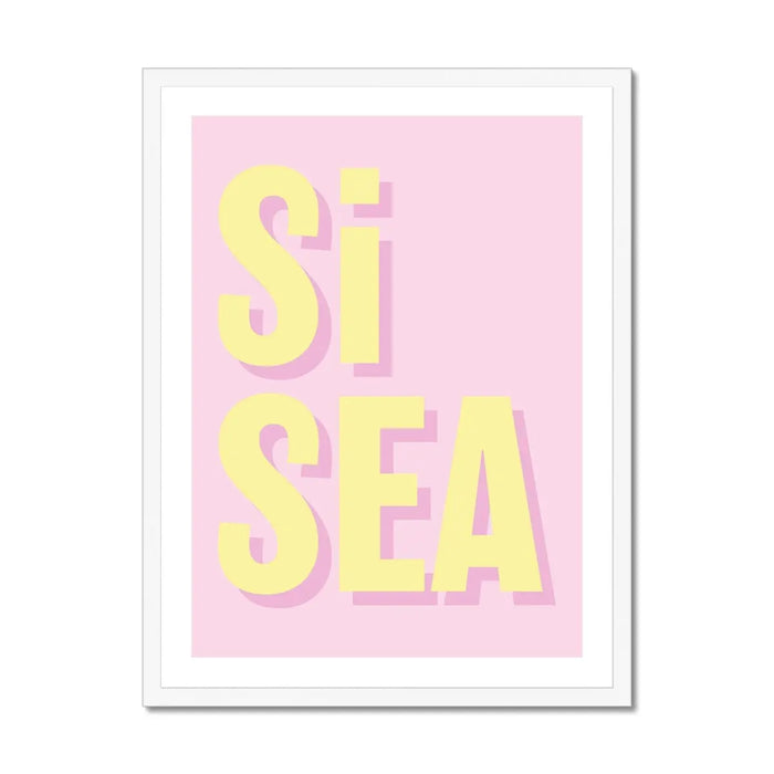 A framed coastal word art print with the text 'Si Sea' in yellow letters on a pink background
