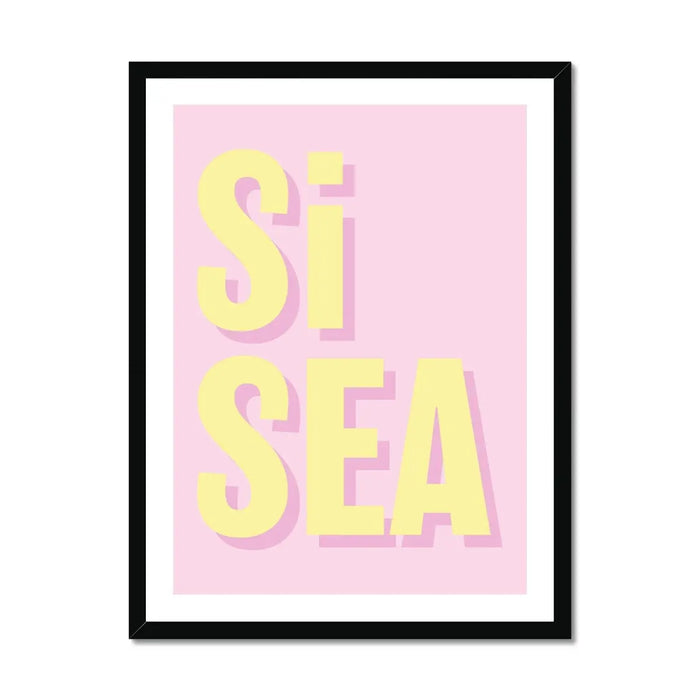 A framed word art print with the text 'Si Sea' in yellow letters on a pink background
