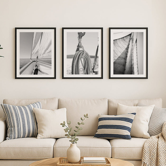 Living room with beige sofa, wooden coffee table, and framed black and white pictures on the wall.