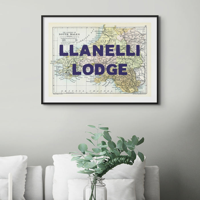 A framed custom map print of South Wales with the text 'Llanelli Lodge' displayed prominently over a vintage map background, indicating a personalised message option.