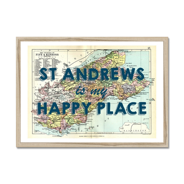 Framed vintage map print of St Andrews featuring text 'St Andrews is my Happy Place' on a colourful map background, encased in a black frame.