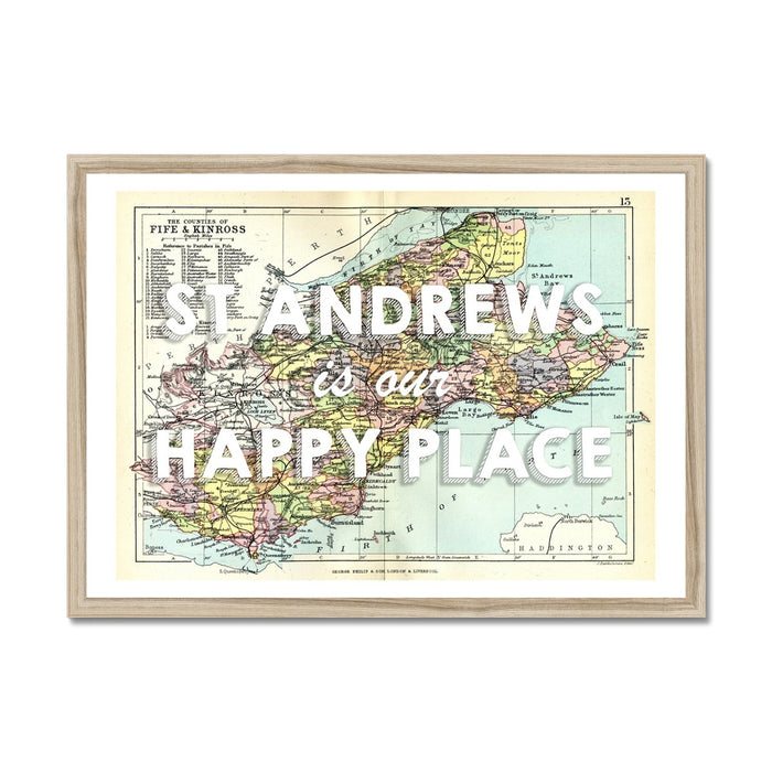 Framed vintage map print of St Andrews featuring text 'St Andrews is my Happy Place' on a colorful map background, encased in a black frame.