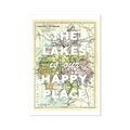 A framed Lake District vintage map print with the text 'The Lakes is our Happy Place' overlaid on it.