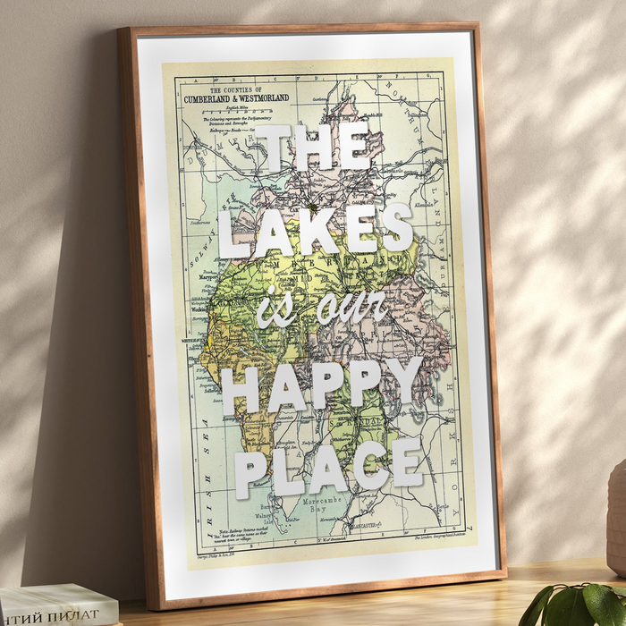A framed map print of the Lake District. A vintage map with the text 'The Lakes is our Happy Place' overlaid on it.