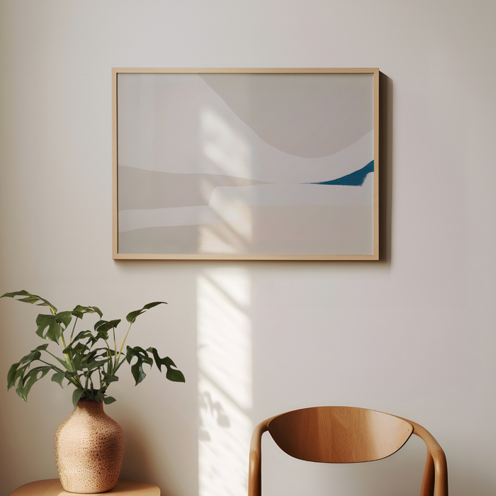 Abstract art piece on a wall with a plant and chair in the foreground