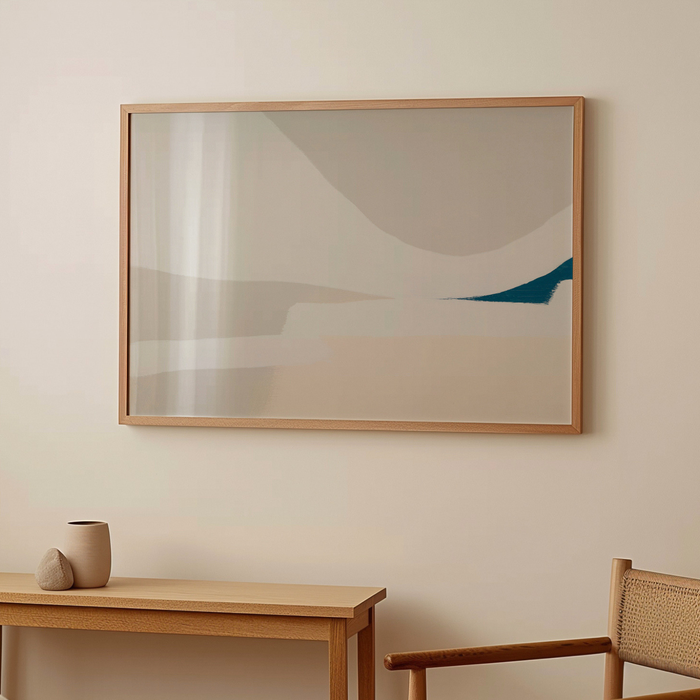 Abstract painting in a wooden frame on a beige wall above a wooden table with decorative items.