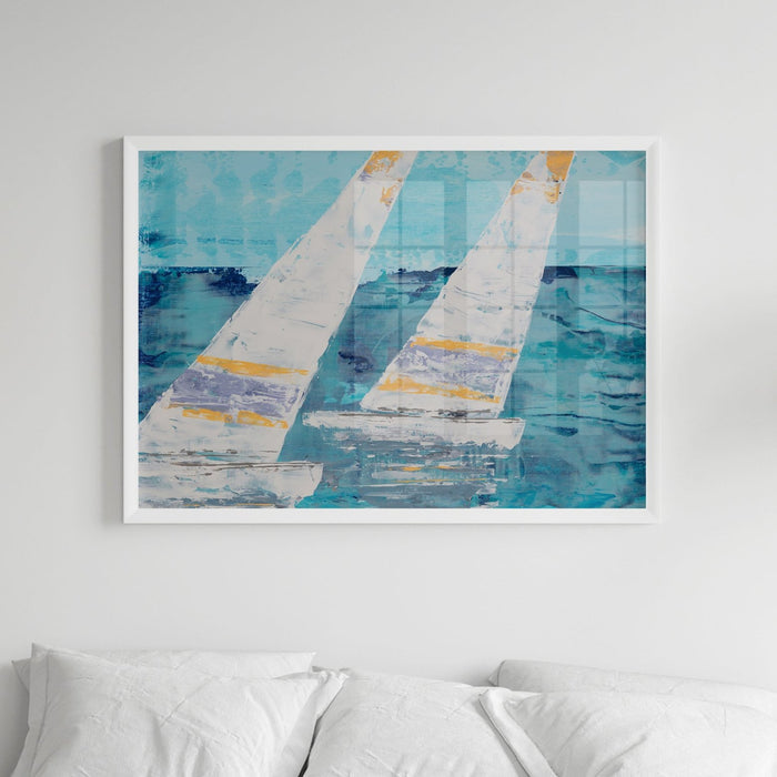 Framed sailing boat art print of two sailing boats with white sails on wall above bed.