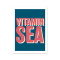 A colourful art print with the text 'VITAMIN SEA' in bold, coral-colored letters, set against a marine blue background.