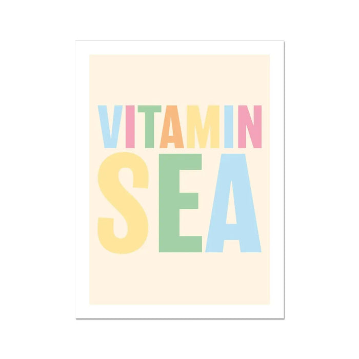 A colourful typography art print with the text 'VITAMIN SEA' in various hues of pink, green, blue, and yellow on a pale sandy background.