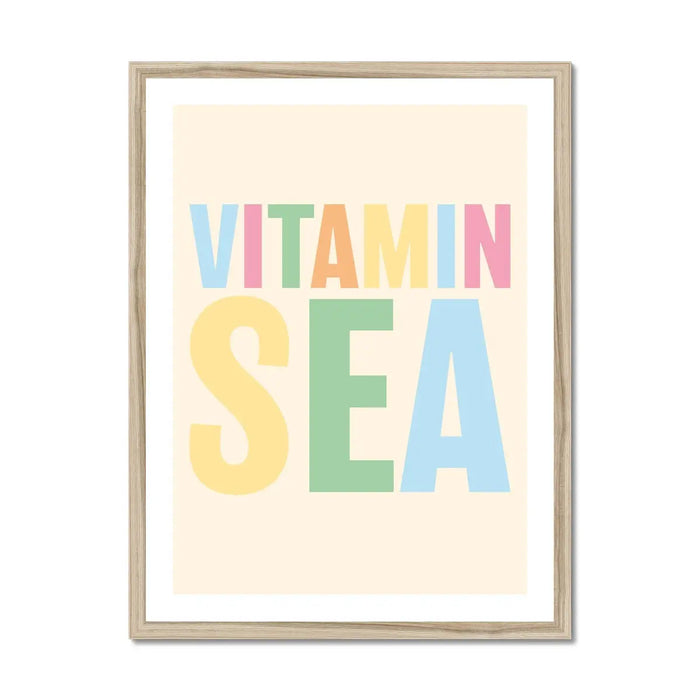 Framed colourful typography art print with the words 'VITAMIN SEA' in multicoloured letters on a beige background.