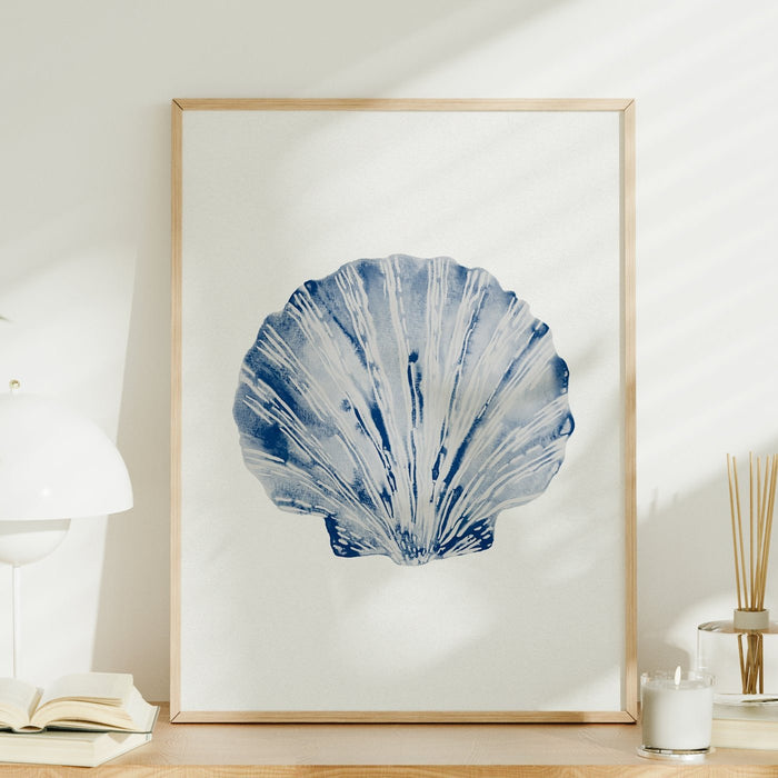 A framed art print of a blue scallop shell on a shelf.