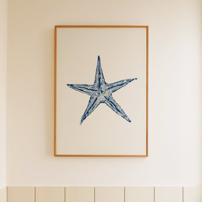 Framed starfish painting on wall in bathroom.