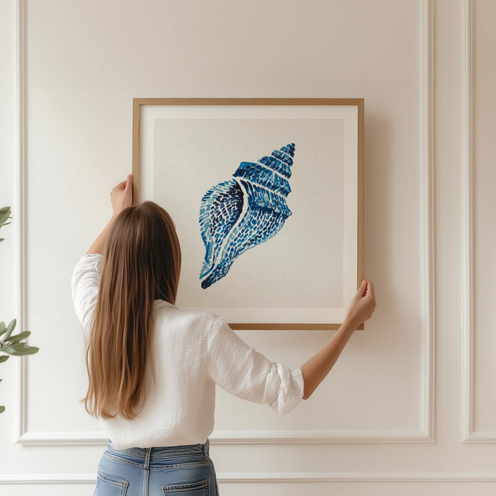 framed painting of a whelk shell being hung on panelled wall.