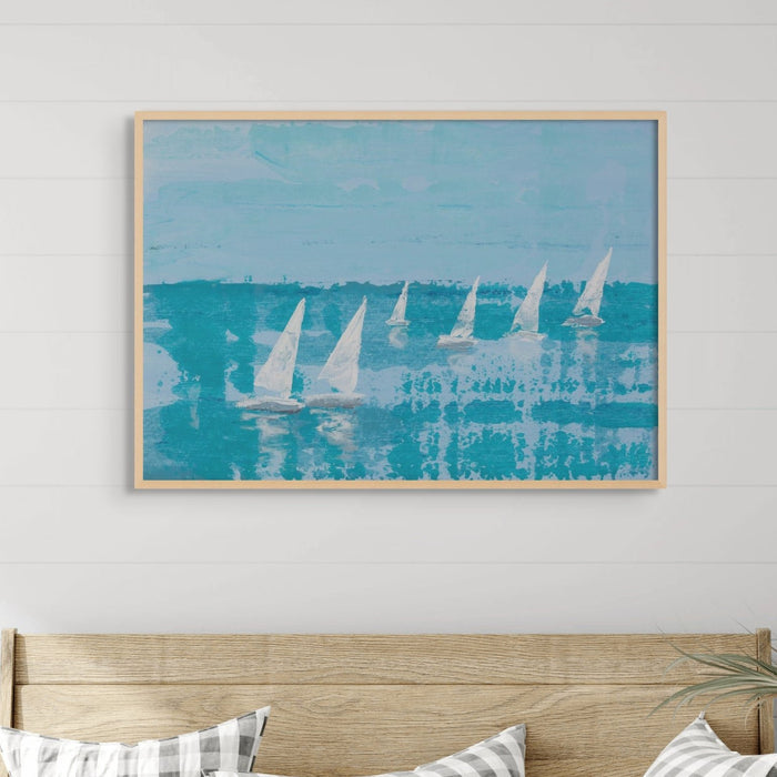 A framed painting featuring white sailboats on a blue ocean backdrop.