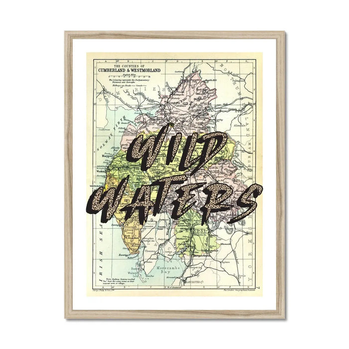 Framed Lake District vintage map art print with the text 'WILD WATERS' overlaid on a map background, in a light wood frame.